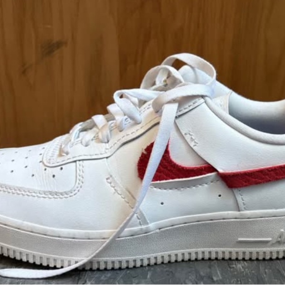 Size W8.5/M7 White Nike Sneakers with Alternating Red and Blue Swoosh